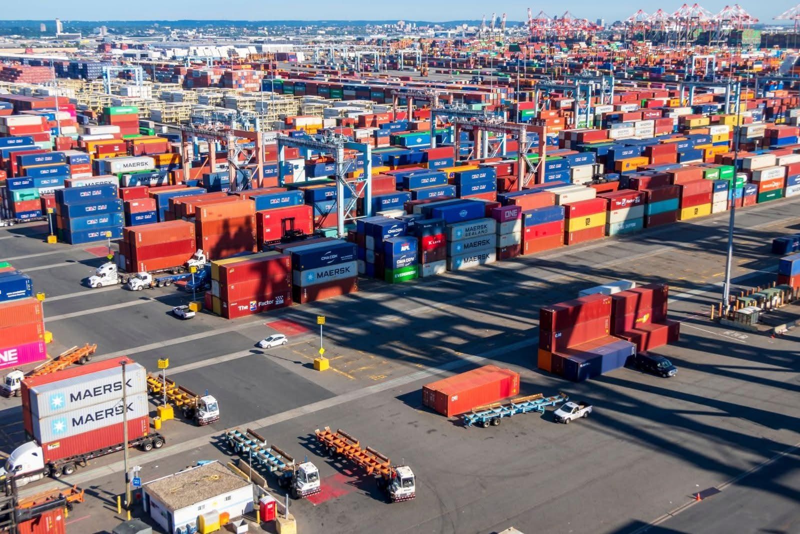 Container terminal yard with chassis and stacked import containers